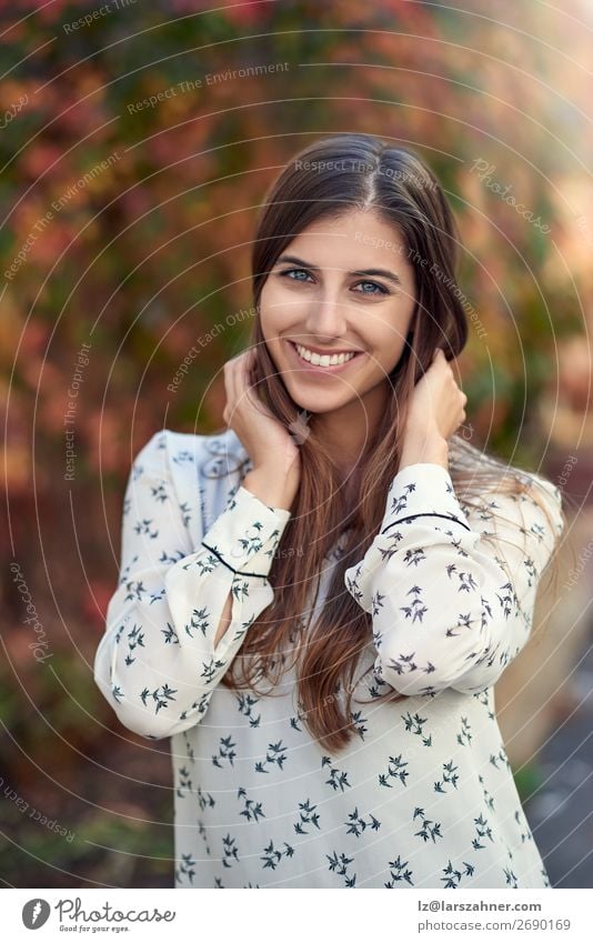 Attractive young woman in a colorful fall street Happy Woman Adults Autumn Leaf Street Fashion Brunette Smiling Laughter Happiness Smart attractive Cheek