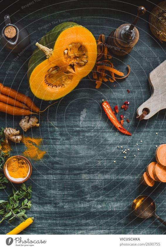 Food background frame with pumpkin and orange color vegetables on kitchen table, top view. Autumn  cooking food place design menu recipes autumn winter healthy