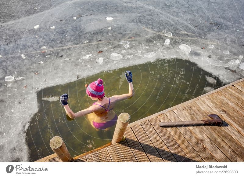 Fit woman performs ice swim in the ice hole. Lifestyle Body Leisure and hobbies Adventure Winter Winter vacation Sports Winter sports Swimming & Bathing