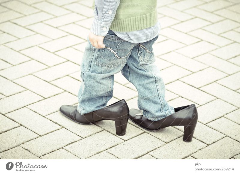 Young boy and girl walking in high-heels Stock Photo - Alamy