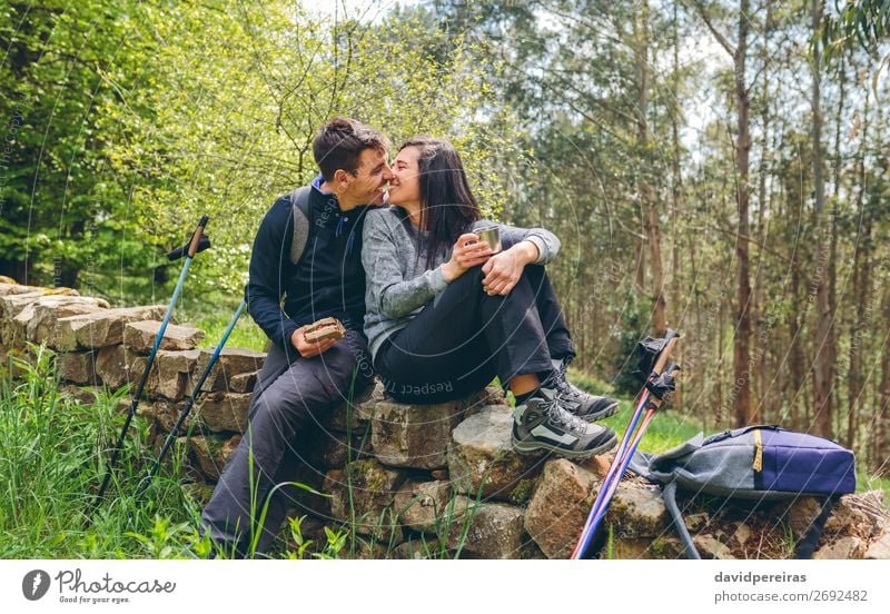 Couple about to kiss while making a break to do trekking Eating Drinking Lifestyle Leisure and hobbies Adventure Mountain Hiking Sports Human being Woman Adults