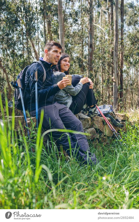 Couple pausing while doing trekking Eating Drinking Lifestyle Happy Leisure and hobbies Adventure Mountain Hiking Sports Climbing Mountaineering Human being