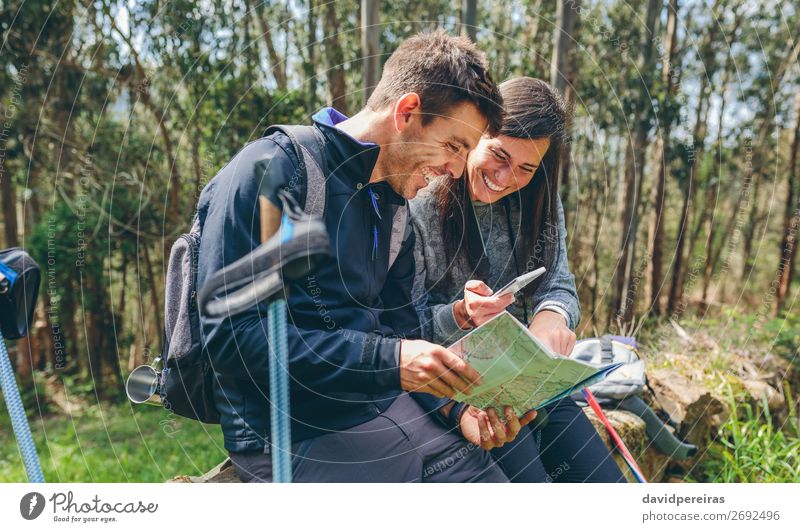Couple doing trekking sitting looking mobile and map Joy Happy Trip Adventure Sightseeing Mountain Hiking Sports PDA Human being Woman Adults Man Nature Autumn