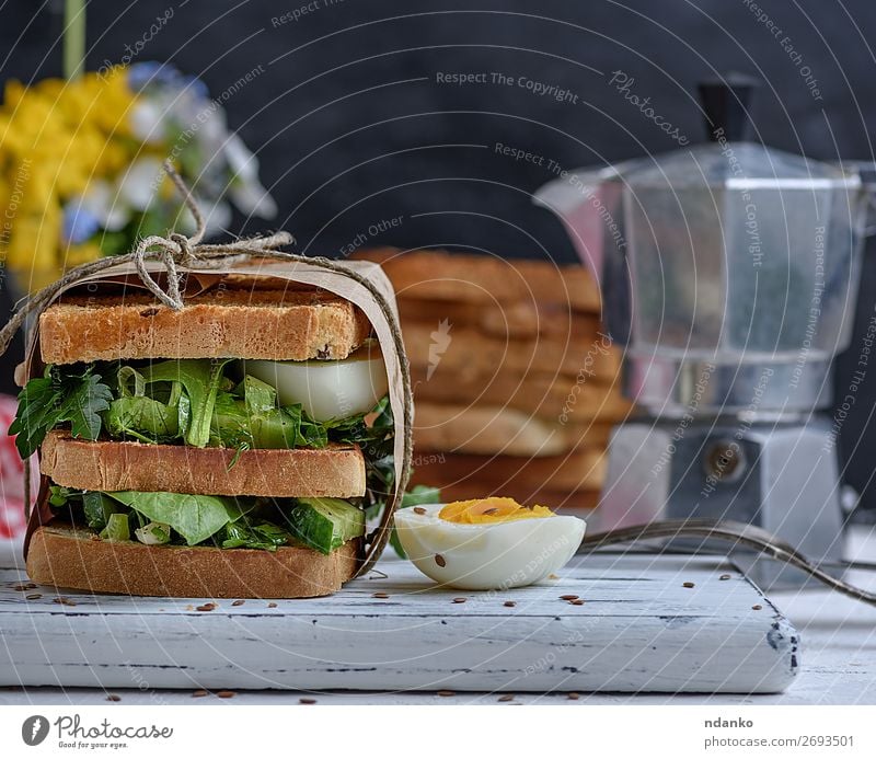 sandwich of French toast and lettuce leaves and boiled egg Meat Vegetable Bread Breakfast Lunch Dinner Vegetarian diet Fast food Table Wood Fresh Delicious