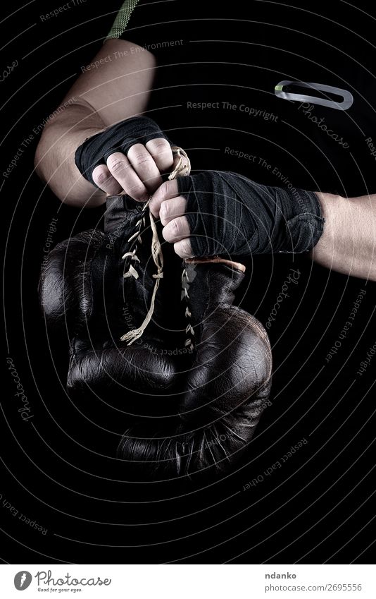 pair of very old boxing sports gloves in men's hands Lifestyle Body Sports Track and Field Success Man Adults Hand 1 Human being 30 - 45 years Leather Gloves
