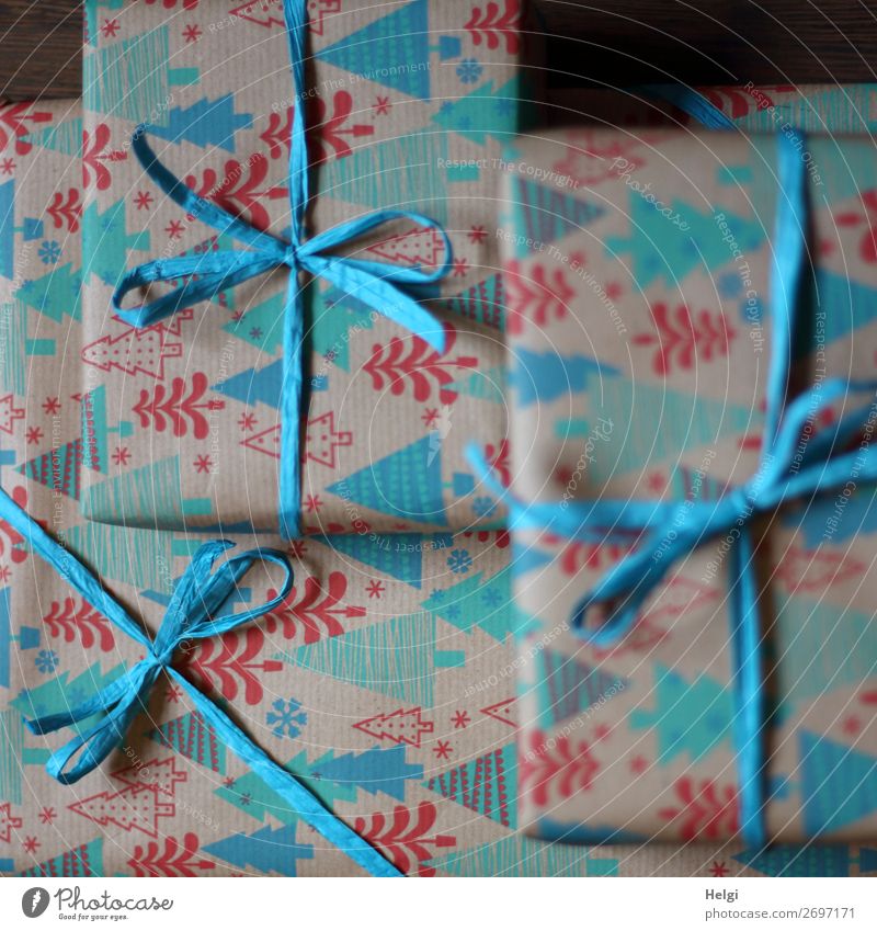 three wrapped gifts in turquoise-red patterned Christmas paper with turquoise bast bows Christmas & Advent Packaging Decoration Bow Gift Bast Paper
