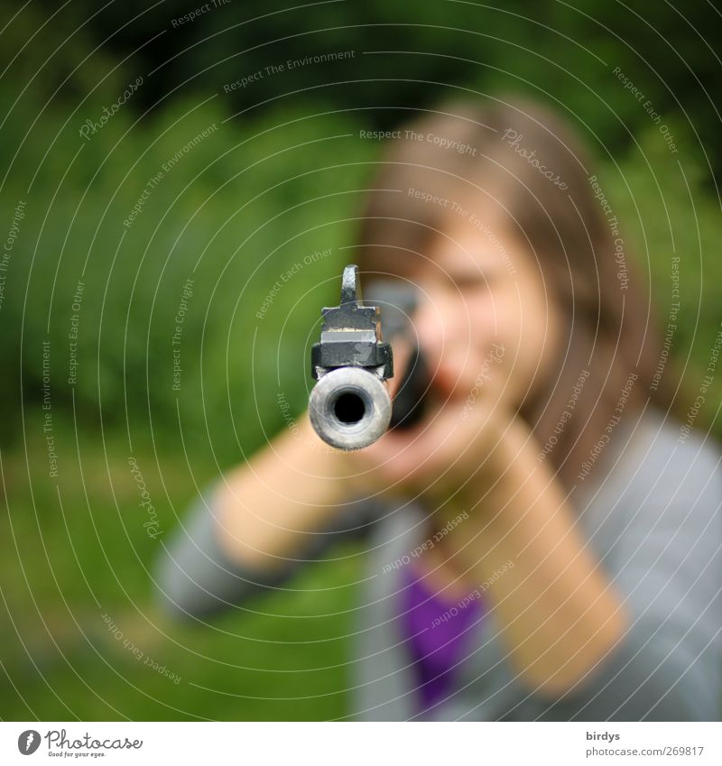Young woman with rifle in attack aims at camera, muzzle of rifle Airgun Youth (Young adults) 1 Human being Summer Rifle Threat Rebellious Feminine