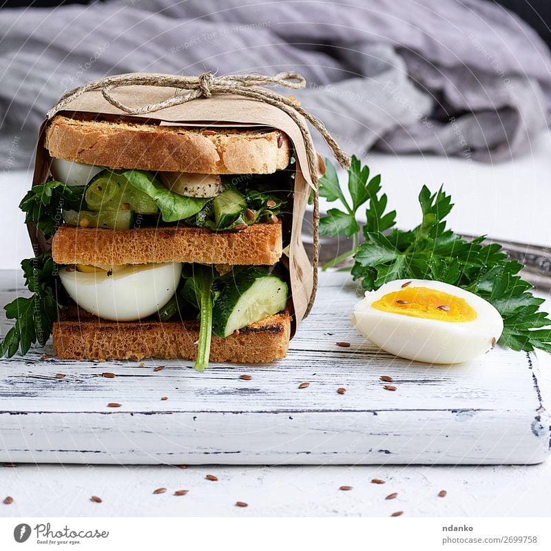 sandwich of French toast and lettuce leaves and boiled egg Meat Vegetable Bread Breakfast Lunch Dinner Vegetarian diet Healthy Eating Table Wood Fresh Delicious