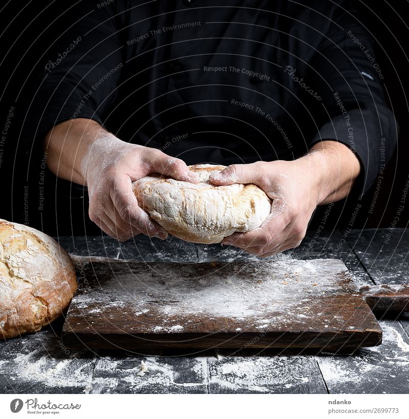 male chef hands hold a whole loaf of baked round bread Bread Nutrition Table Kitchen Human being Hand Make Dark Fresh Brown Black White Tradition Baking Baker