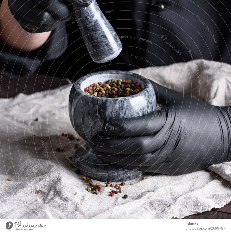 cook in black latex gloves holding a stone mortar with pepper Herbs and spices Bowl Table Kitchen Work and employment Cook Tool Human being Man Adults Hand