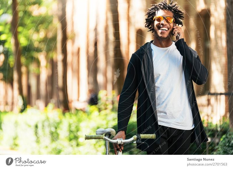 Afro young man using mobile phone and fixed gear bicycle Man Youth (Young adults) African Black Lifestyle attractive handsome urban Modern Self-confident Mobile