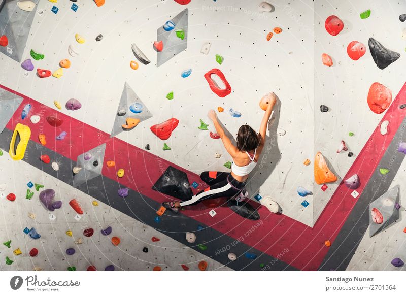 Woman practicing rock climbing on artificial wall indoors. Climber Climbing Rock Wall (building) Gymnasium Youth (Young adults) Fitness Sports