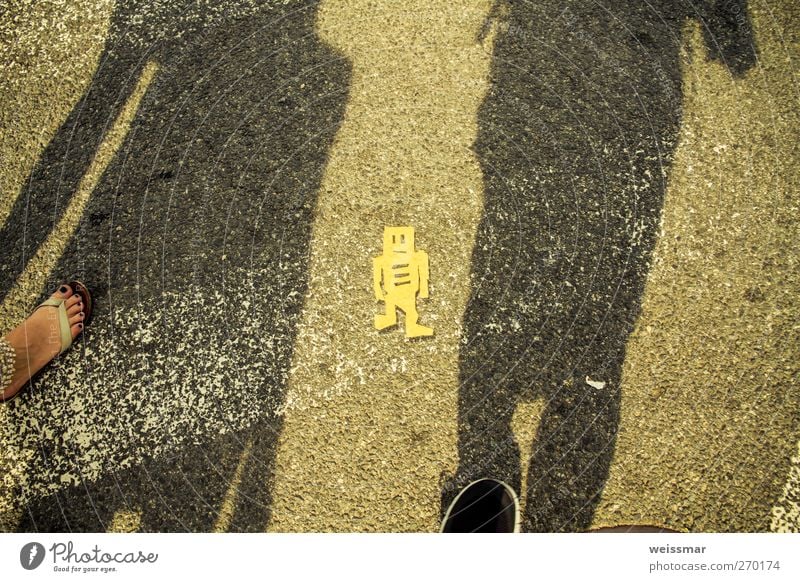 A sign from another world Robot Robotics Technology High-tech Shadow Shadow play 2 Human being Washington DC USA North America Town Street Walking Warmth Yellow