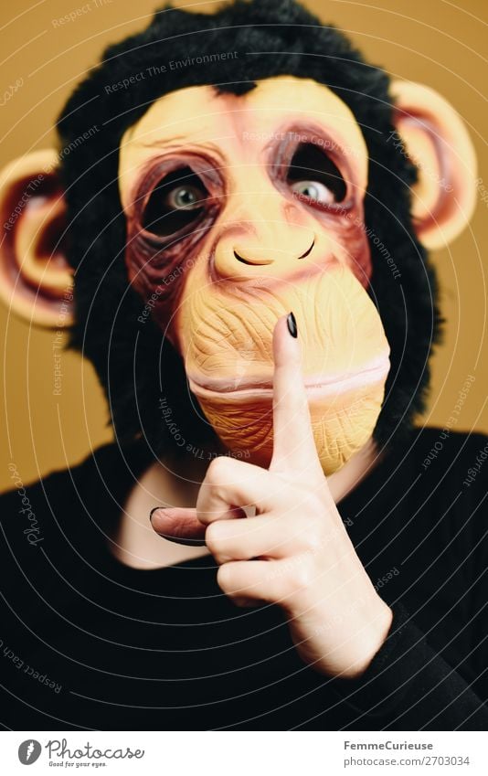 Person with monkey mask making psst gesture 1 Human being Animal Joy Gesture Calm Silent Bans Pelt Mask Monkeys Chimpanzee Evolution Carnival Carnival costume