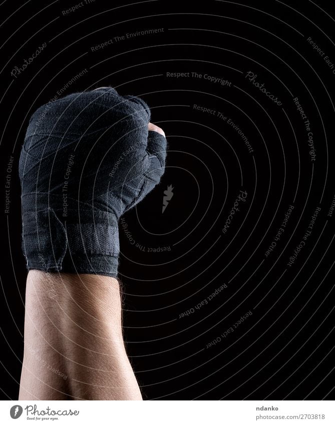 hand is wrapped in a black sports textile bandage Lifestyle Fitness Sports Track and Field Man Adults Hand Fingers 1 Human being 30 - 45 years Aggression Dark