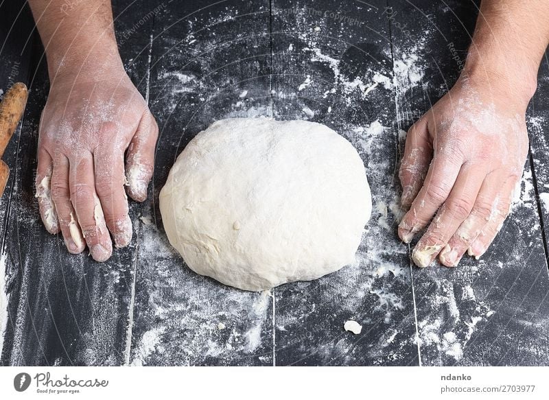 kneaded yeast dough made from white wheat flour Dough Baked goods Bread Nutrition Table Kitchen Cook Human being Man Adults Hand Wood Make Fresh Black White