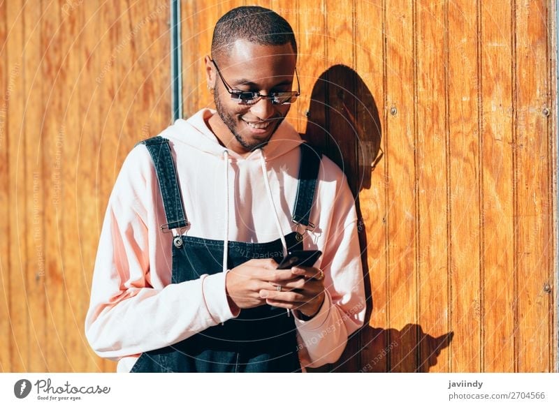 Young Black Man Using Smart Phone Outdoors A Royalty Free Stock Photo From Photocase A pda is a portable device used for jotting down notes and keeping track of contacts and schedules. photocase