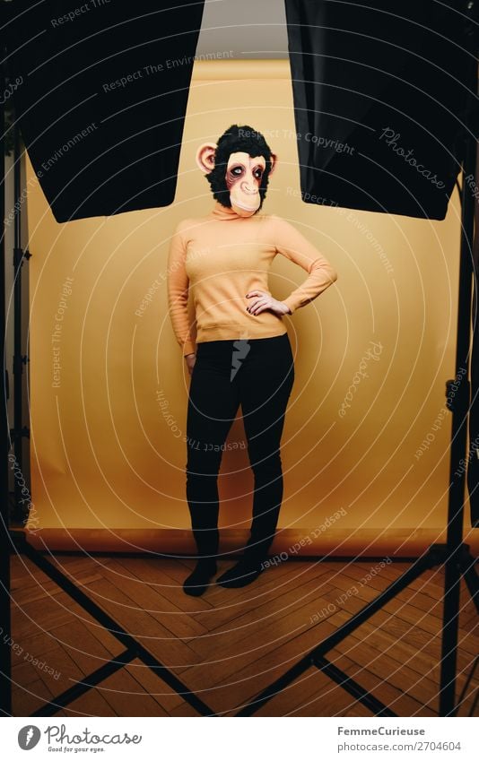Woman with monkey mask posing in photo studio Feminine Adults 1 Human being 18 - 30 years Youth (Young adults) 30 - 45 years Joy Photographic studio Floorboards