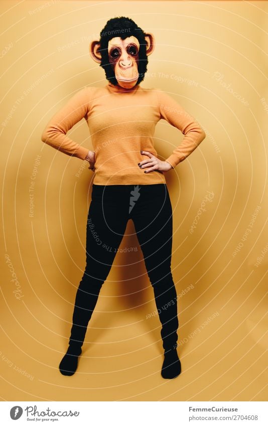 Woman with monkey mask posing against a yellow background Feminine Adults 1 Human being 18 - 30 years Youth (Young adults) 30 - 45 years Joy Carnival