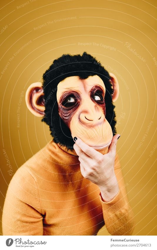 Woman with monkey mask looking thoughtful Feminine Adults 1 Human being 18 - 30 years Youth (Young adults) 30 - 45 years Joy Think Meditative Dreamily Evolution