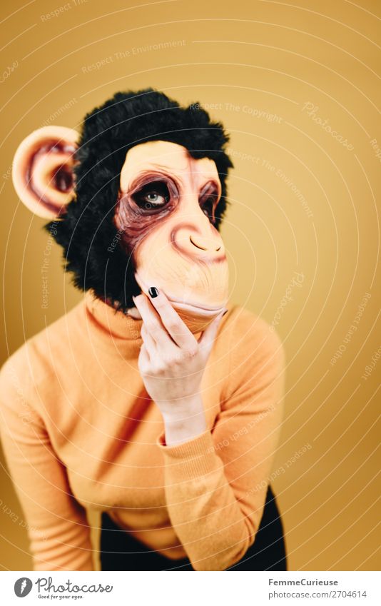 Woman with monkey mask posing against a yellow background Feminine Adults 1 Human being 18 - 30 years Youth (Young adults) 30 - 45 years Joy Funny Mask Carnival