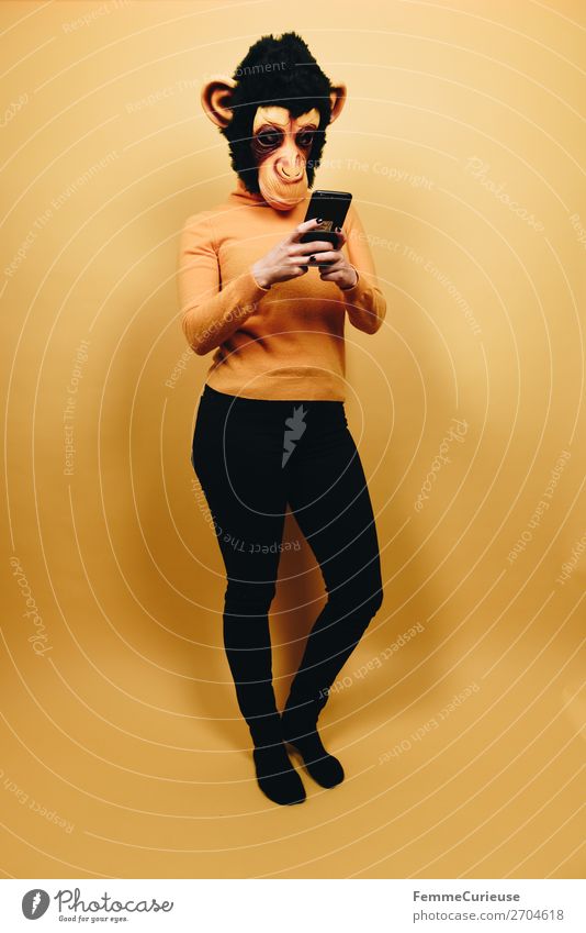 Woman with monkey mask looking at her smartphone Technology Entertainment electronics Feminine Adults 1 Human being 18 - 30 years Youth (Young adults)