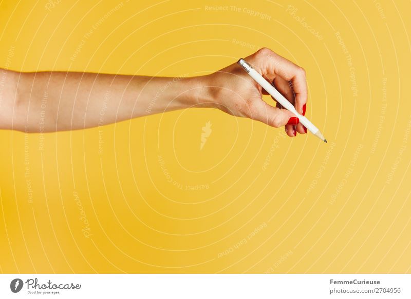 Forearm and hand with pencil against a yellow background Feminine Young woman Youth (Young adults) Woman Adults 1 Human being 18 - 30 years 30 - 45 years