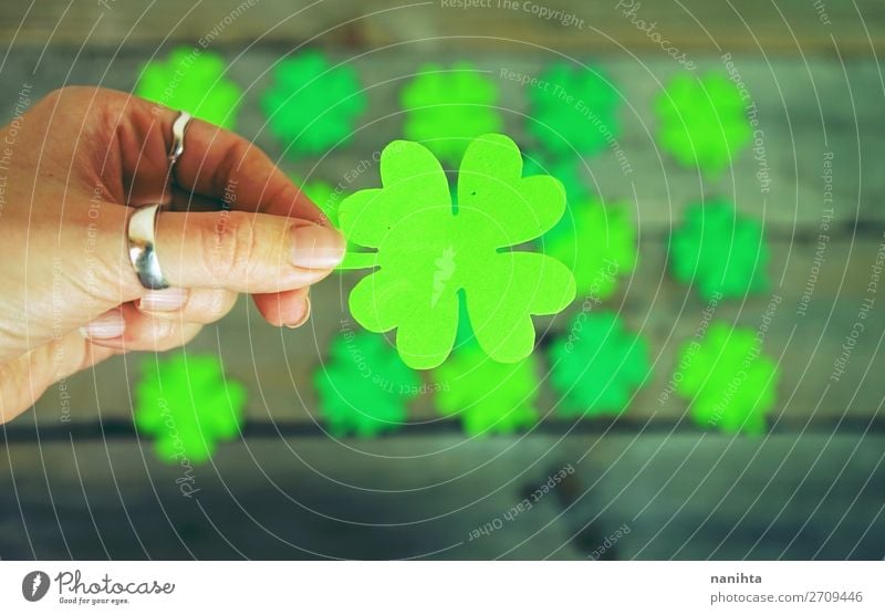 Beautiful close-up of woman hand holds a clover Style Design Happy Table Wallpaper Feasts & Celebrations Woman Adults Hand Culture Leaf Ring Paper Wood Ornament