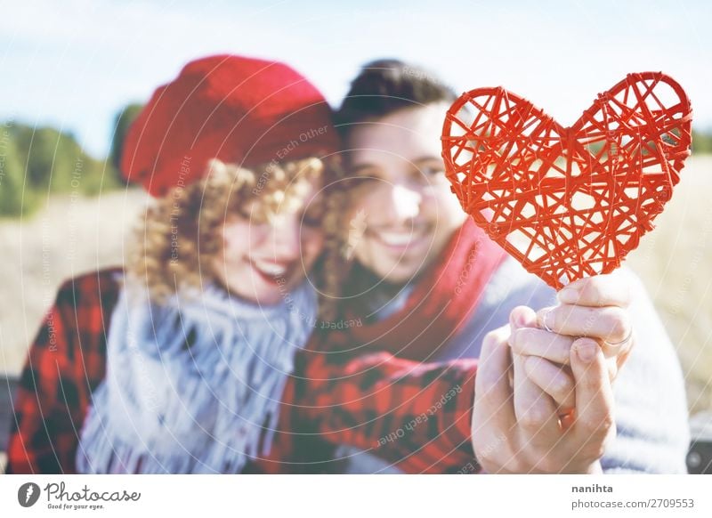 close-up of a beautiful red heart holding by a couple Lifestyle Happy Beautiful Sunbathing Valentine's Day Human being Masculine Feminine Woman Adults Man