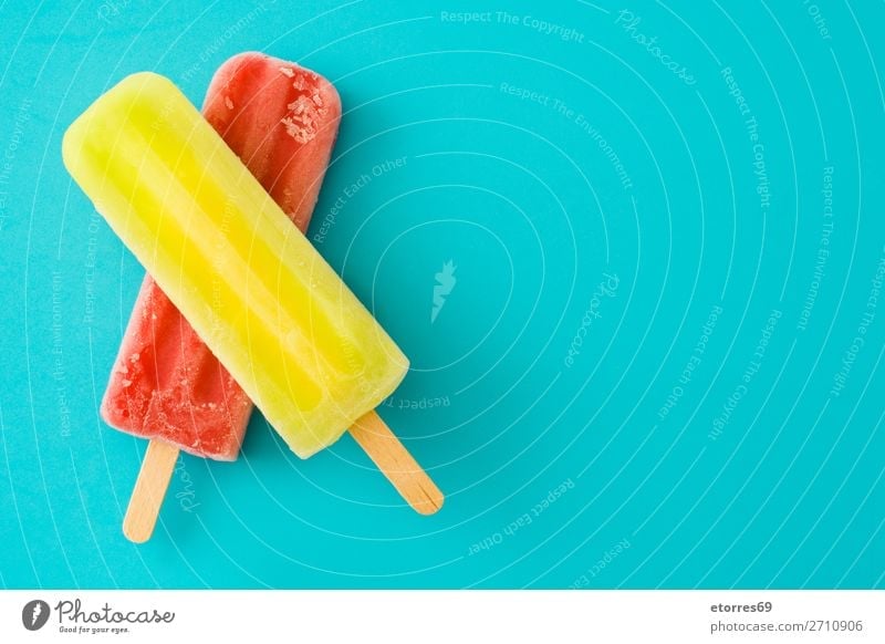 Lemon and strawberry popsicles on blue background Food Healthy Eating Food photograph Fruit Dessert Ice cream Candy Fresh Cold Sweet Blue Multicoloured Yellow