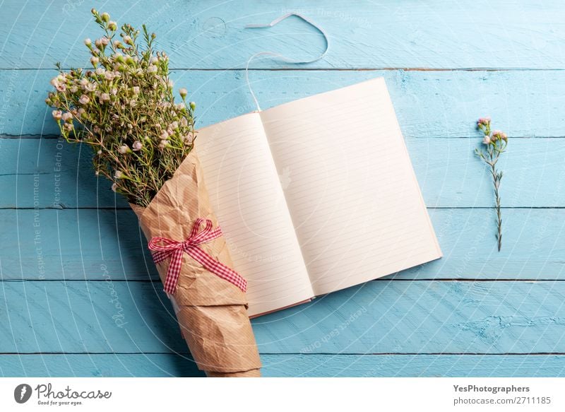 Flower bouquet and open notebook on a blue table Elegant Desk Feasts & Celebrations Valentine's Day Mother's Day Wedding Plant Bouquet Love Happiness Fresh Blue