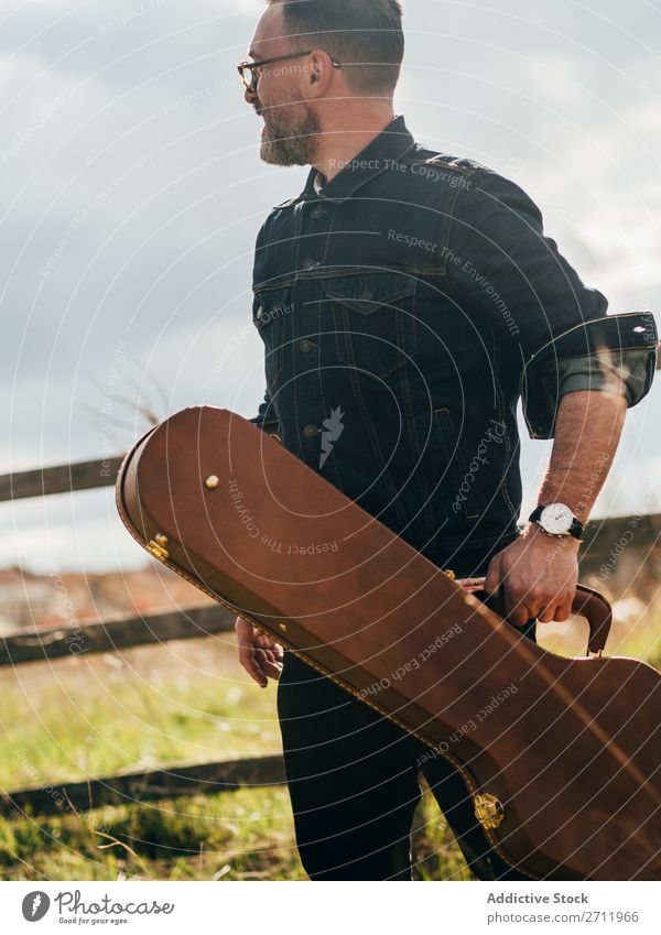 Adult man with guitar case Man Guitar Nature Musician To fall Stand Looking away Adults Rural Fence Lifestyle Human being Summer Easygoing Acoustic handsome Guy