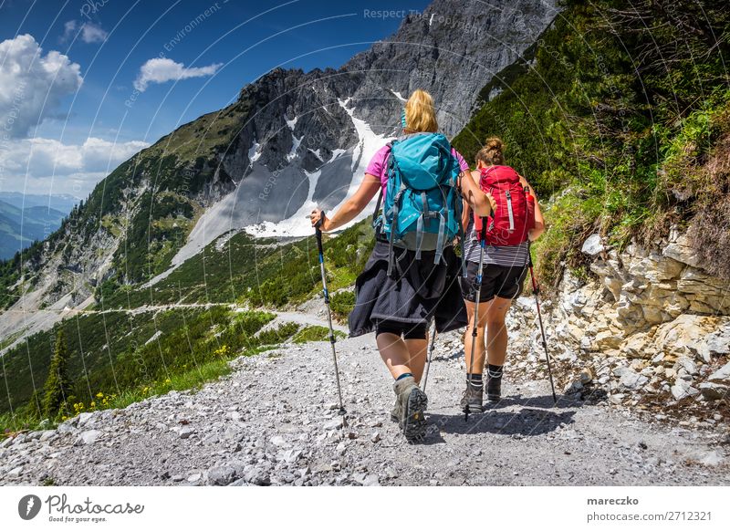 Two women with hiking equipment Fitness Leisure and hobbies Tourism Trip Adventure Summer Summer vacation Mountain Hiking Sports Training Nature Landscape Alps