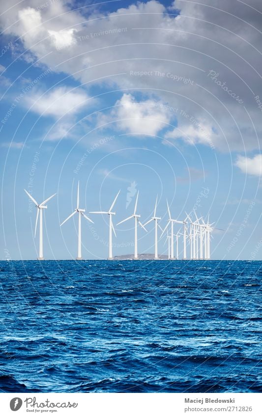 Offshore windmill farm on a sunny day Ocean Industry Energy industry Renewable energy Wind energy plant Environment Nature Sky Clouds Horizon Sustainability