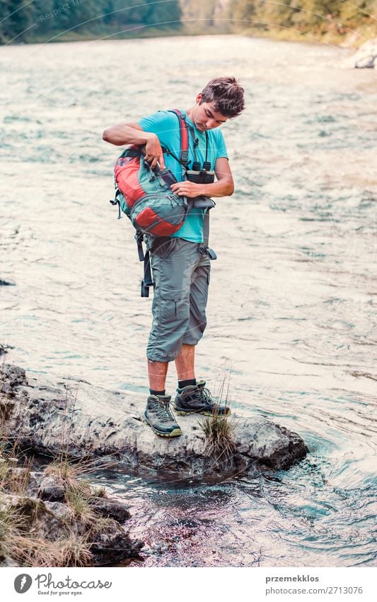 Young boy takes out outdoor mug to take pure water from a river Life Trip Adventure Summer Hiking Human being Boy (child) Young man Youth (Young adults) Man