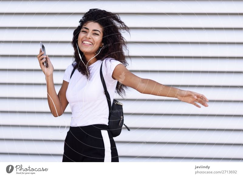 African woman listening to music with earphones and smartphone Style Joy Happy Beautiful Hair and hairstyles Music Sports Telephone PDA Technology Human being