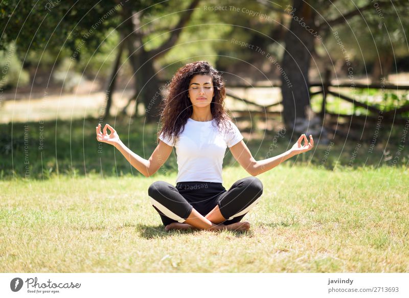 Young woman doing yoga in nature. Lotus figure. - a Royalty Free Stock  Photo from Photocase