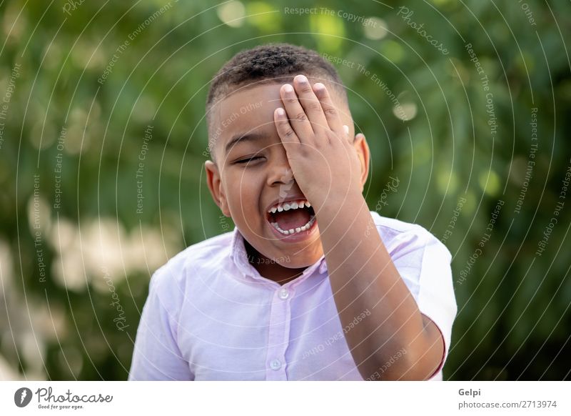 Happy child covering his eye in the park Lifestyle Joy Face Playing Child Human being Boy (child) Man Adults Infancy Happiness Small Funny Cute Black Emotions