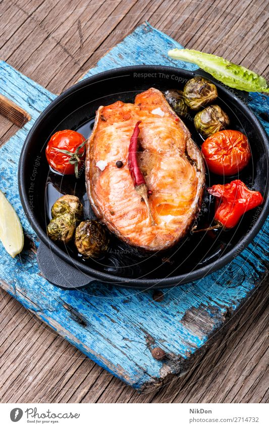 Salmon roasted in pan fish grilled salmon steak baked salmon frying pan seafood healthy meal fish steak vegetable cutting board diet prepared pepper portion
