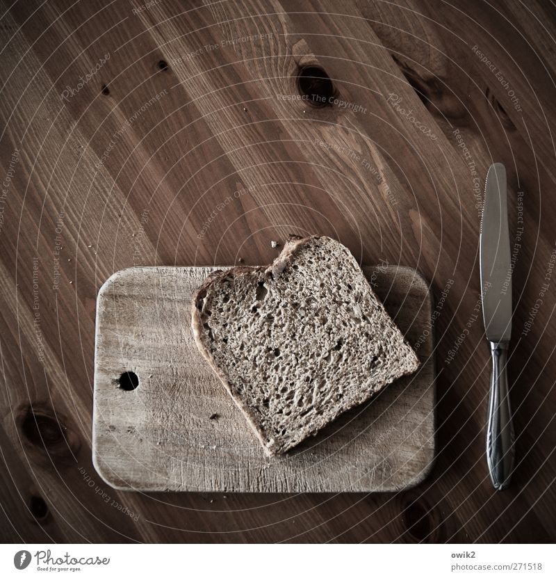 Cold kitchen Food Bread Slice of bread slice sliced bread Nutrition Breakfast Diet Knives Chopping board Tabletop Wood Wooden board Wooden table Metal Lie