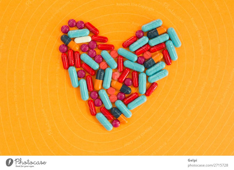 Pills arranged in heart shape on an orange background Bottle Health care Medical treatment Illness Medication Science & Research Hospital Heart Blue White Pain