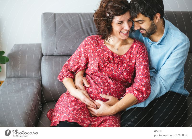 Loving happy pregnant couple at home Happy Beautiful Body Baby Woman Adults Man Parents Mother Father Family & Relations Couple Flower Dress Touch Smiling
