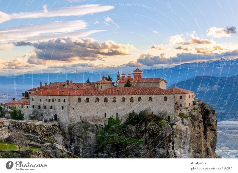 Agios Stephanos or Saint Stephen monastery located on the huge rock with mountains and town landscape in the background, Meteors, Trikala, Thessaly, Greece