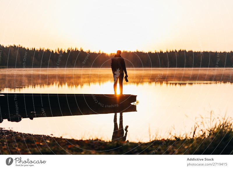 Person on lakeside in morning haze traveler Lake Morning Calm Reflection tranquil Multicoloured Freedom Landscape scenery Vacation & Travel Nature Peaceful