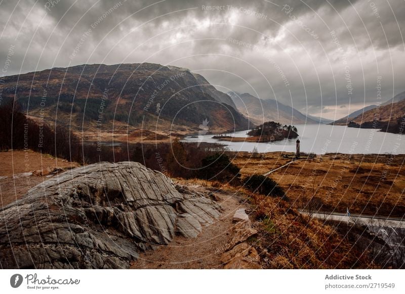 Coast of mountain lake Rock Lake Hill Mountain Landscape Nature Water Natural Stone Beautiful Fog Clouds Scotland Grass Vacation & Travel Cliff Vantage point