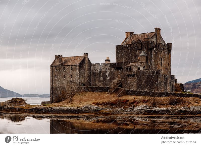 Historic castle at lake Castle Old Coast Rock Lake Hill Mountain Landscape Nature Water Natural mansion big Stone Beautiful Clouds Scotland Grass