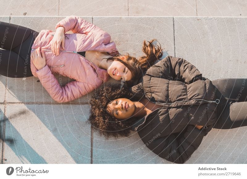 Women lying on ground on street Woman pretty Beautiful Youth (Young adults) Park Looking into the camera Ground Lie (Untruth) Cool (slang) City Town Style