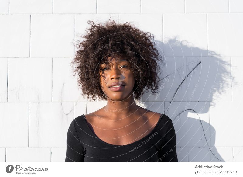 Ethnic woman at white wall Woman pretty Beautiful Youth (Young adults) Portrait photograph Human being Attractive Curly Black Face Nationalities and ethnicity