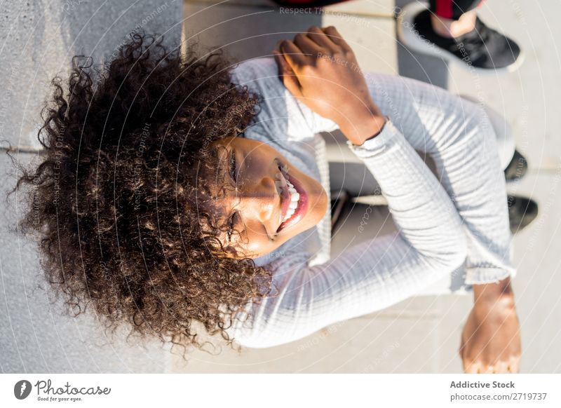 Pretty ethnic woman on steps Woman Ethnic pretty Beautiful Youth (Young adults) Portrait photograph Smiling Cheerful delighted Human being Attractive Curly