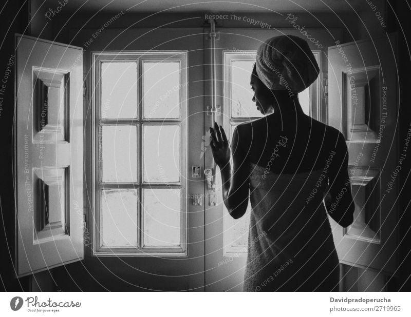 Woman wrapped in a towel looking by a vintage window. Window Black Adults Background picture Beauty Photography Attractive Considerate Ethnic Rear view Bedroom